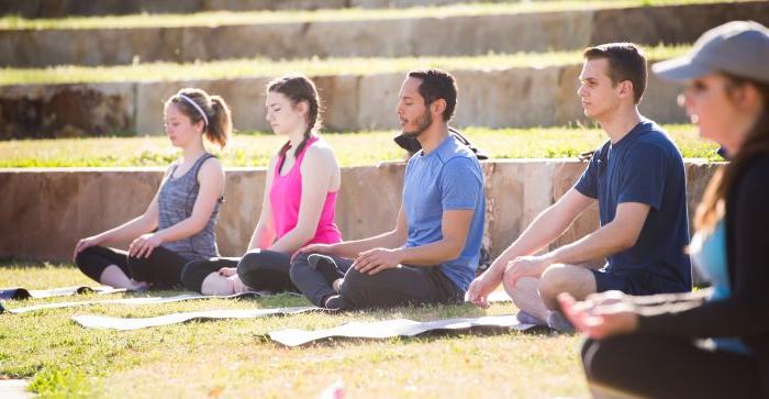 Students meditate on the outdoor amphitheater lawn at A&M-Commerce